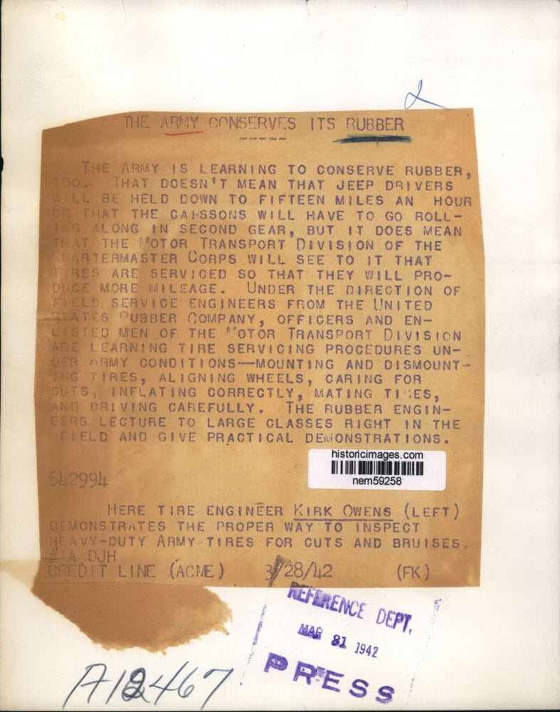 1942 Press Photo Tire engineer Kirk Owens inspects Army tires to conserve rubber