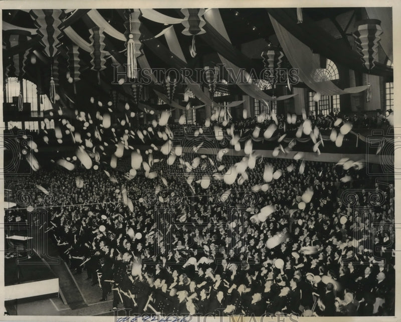 Load image into Gallery viewer, 1941 Press Photo 1941 midshipmen graduates toss their hats at the Dahlgren Hall
