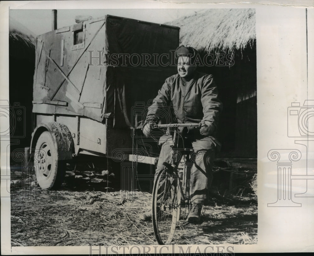 1951 Press Photo Herman Wieser Rides Bicycle to Pull Switchboard Around in Korea- Historic Images