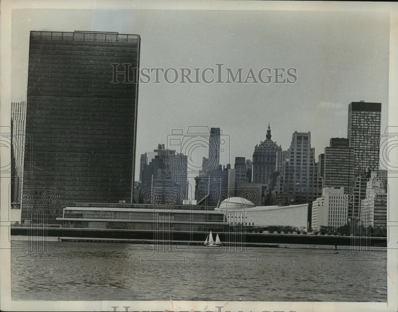 Load image into Gallery viewer, 1961 Press Photo New York sailboat on East River past UN Headquarters NYC
