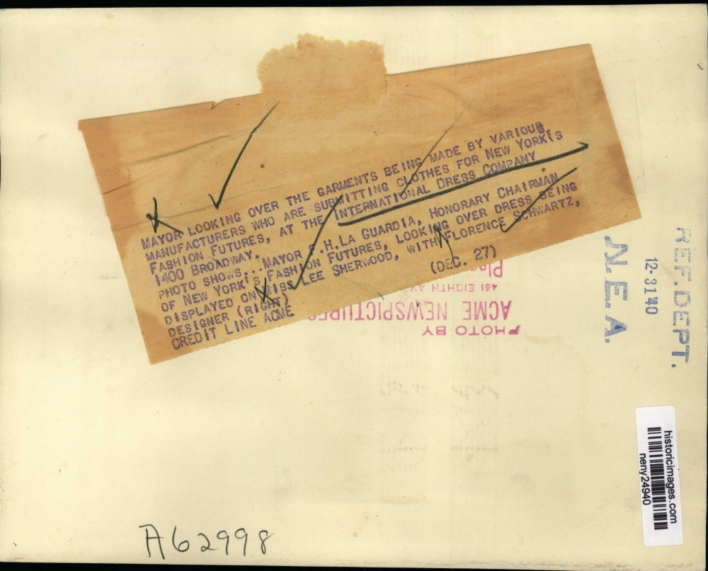 1940 Press Photo New York Mayor FH LaGuardia looks over garments NYC - neny24940