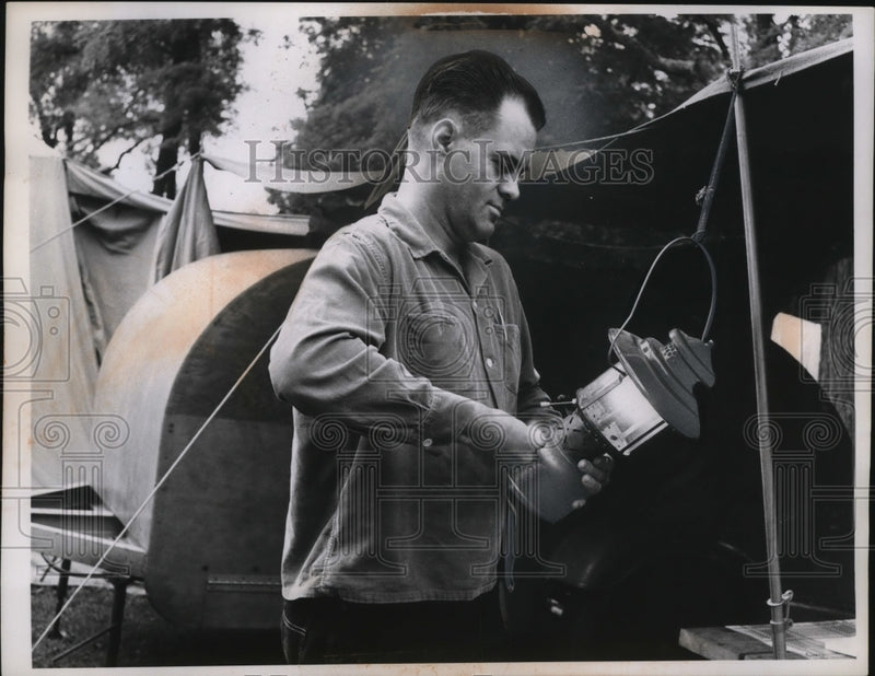 Load image into Gallery viewer, 1959 Press Photo Man Lighting Lantern - neo03068
