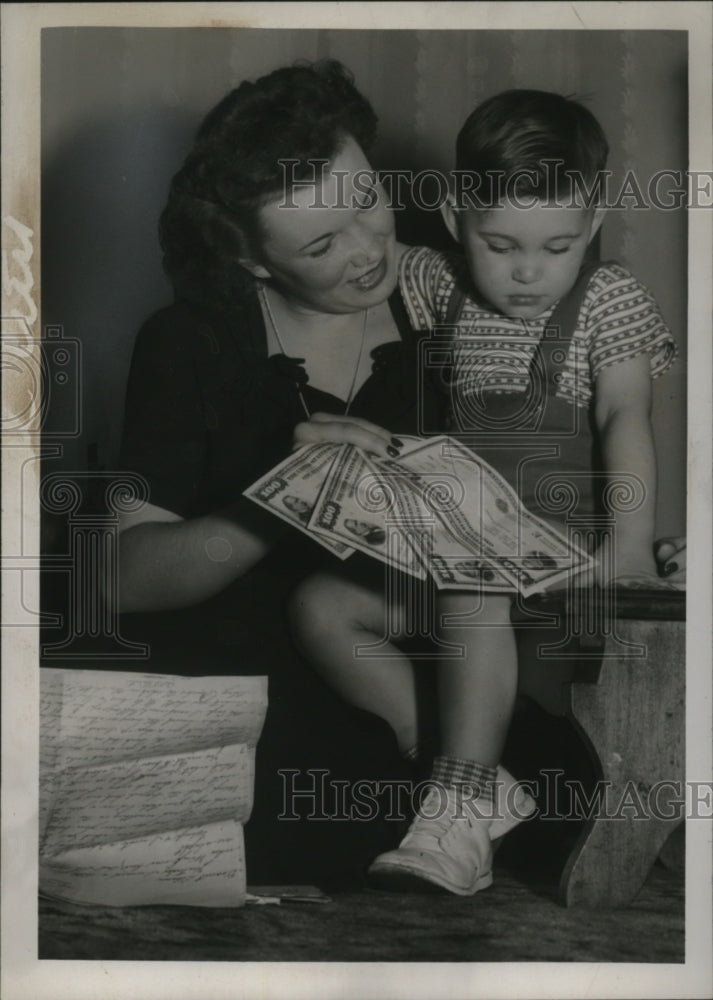 1945 Press Photo Mrs. Robert Foster Showing Bonds to Her Son Robert,Jr