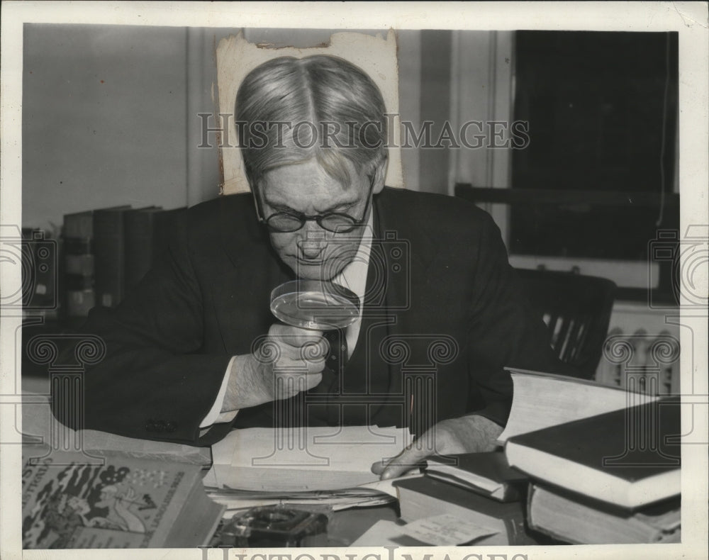 1939 Press Photo Emerson B. Christie Looking Over Papers with Magnifying Glass