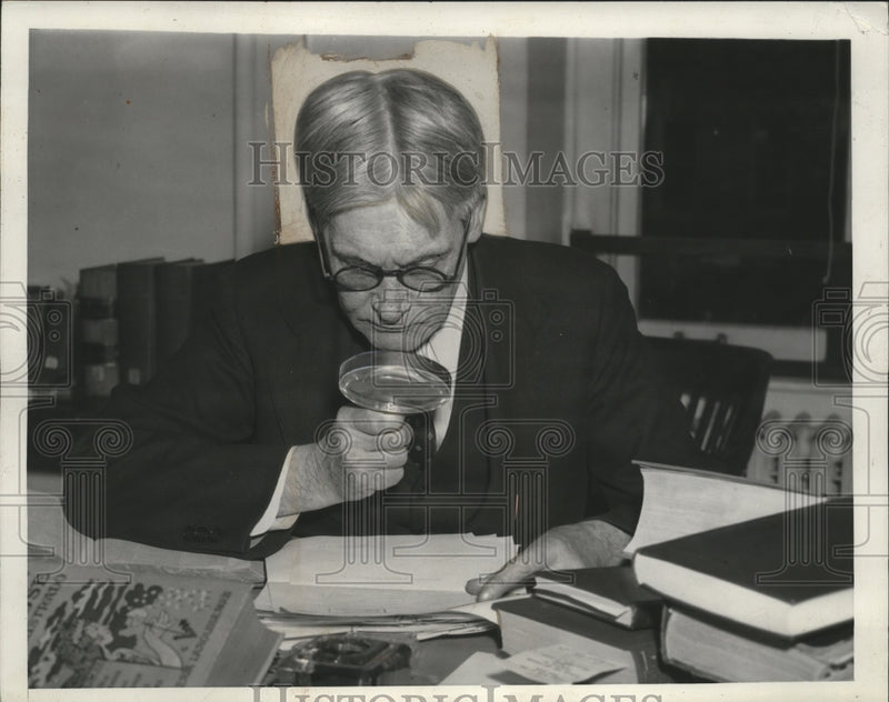 Load image into Gallery viewer, 1939 Press Photo Emerson B. Christie Looking Over Papers with Magnifying Glass
