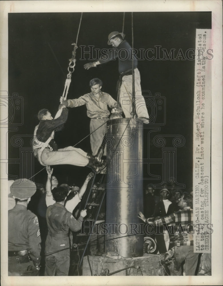 1949 Press Photo Dr. Robert McCulloch hoisted before descent into well in CA