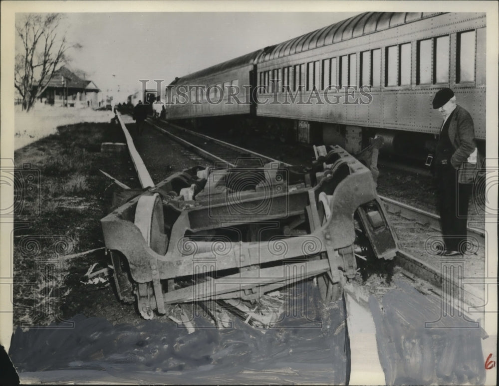 1951 Press Photo A man looks at wreckage of a railroad crash - neo13616