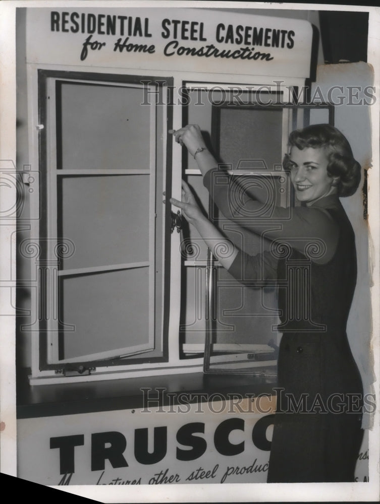 Load image into Gallery viewer, 1957 Press Photo Judy Stickovitch with window casements of Trusco in Cleveland
