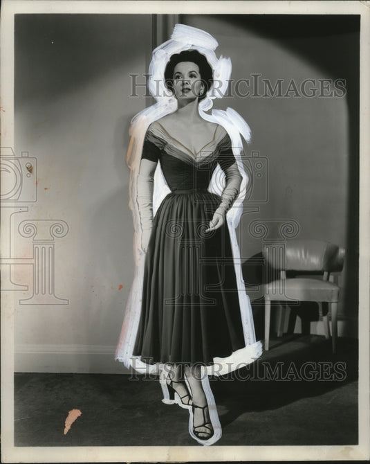 1953 Press Photo Low cut evening wear dress in dark fabric on a model