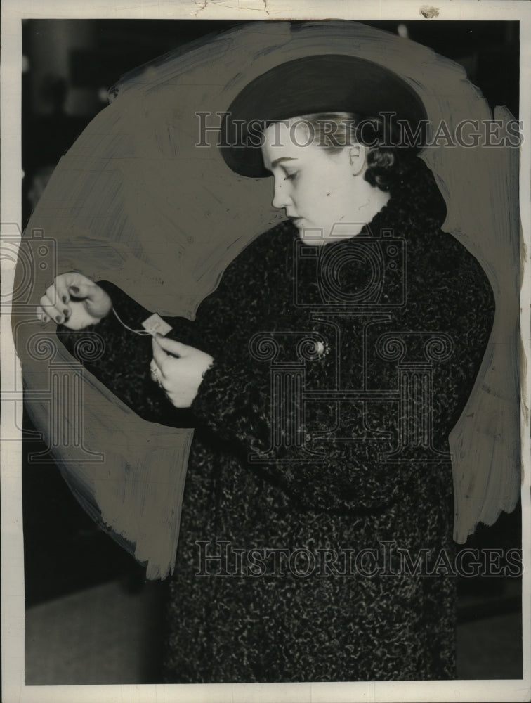 1937 Press Photo Ms. Joe Hopper Examines Coat Price - neo21193
