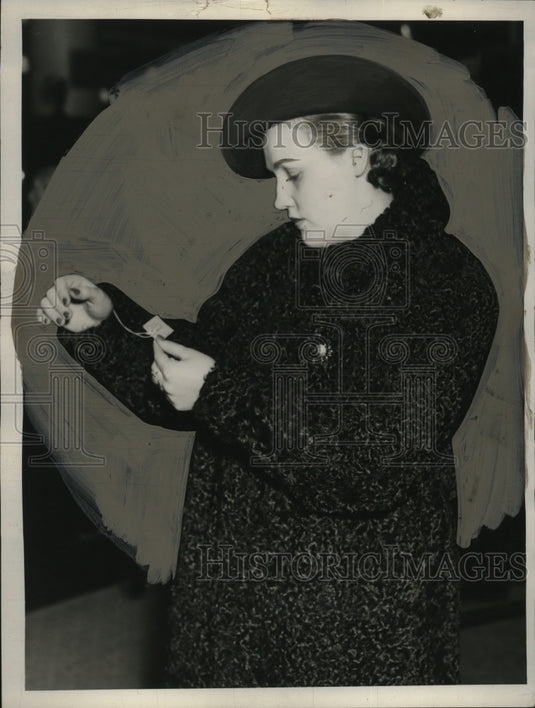 1937 Press Photo Ms. Joe Hopper Examines Coat Price - neo21193