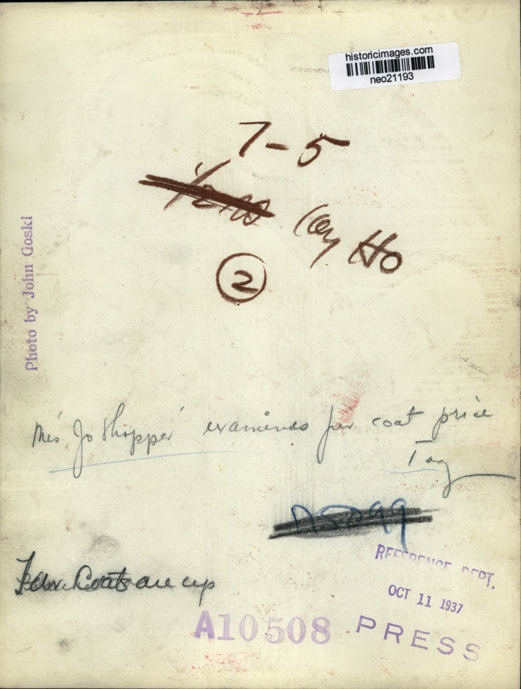 1937 Press Photo Ms. Joe Hopper Examines Coat Price - neo21193