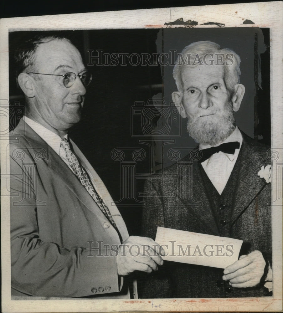 1945 Press Photo Bernard Merkel Receives Early Insurance Check from J.M. Qualey