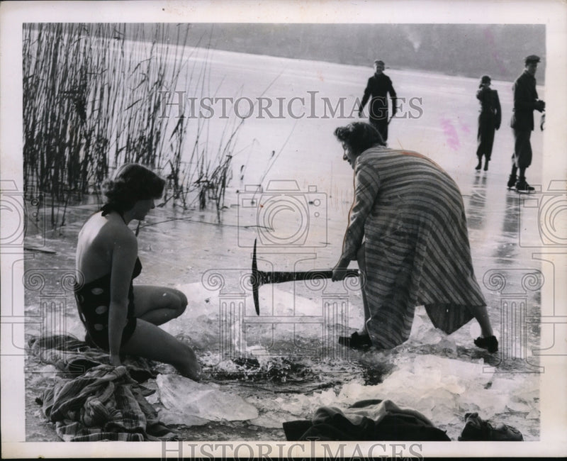 Load image into Gallery viewer, 1950 Press Photo Women chop hole in ice for a swi as others skate - nep06828
