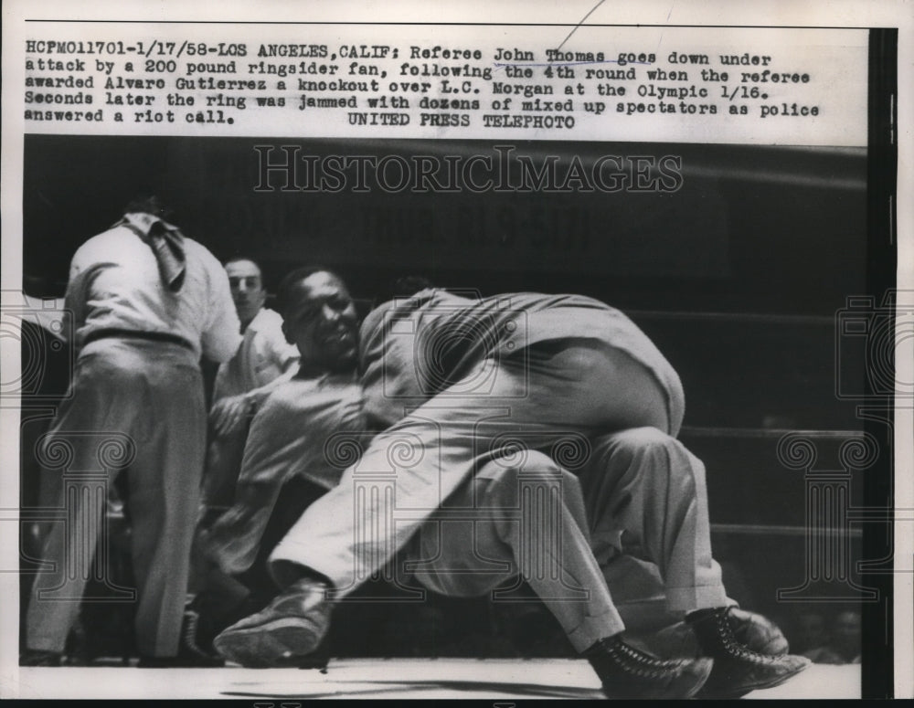 1958 Press Photo Referee John Thomas was attacked by a ringsider fan - nes24271- Historic Images