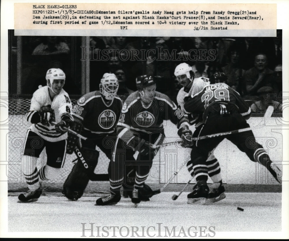 1983 Press Photo Edmonton Oilers goalie Andy Moog gets help from Randy Gregg- Historic Images