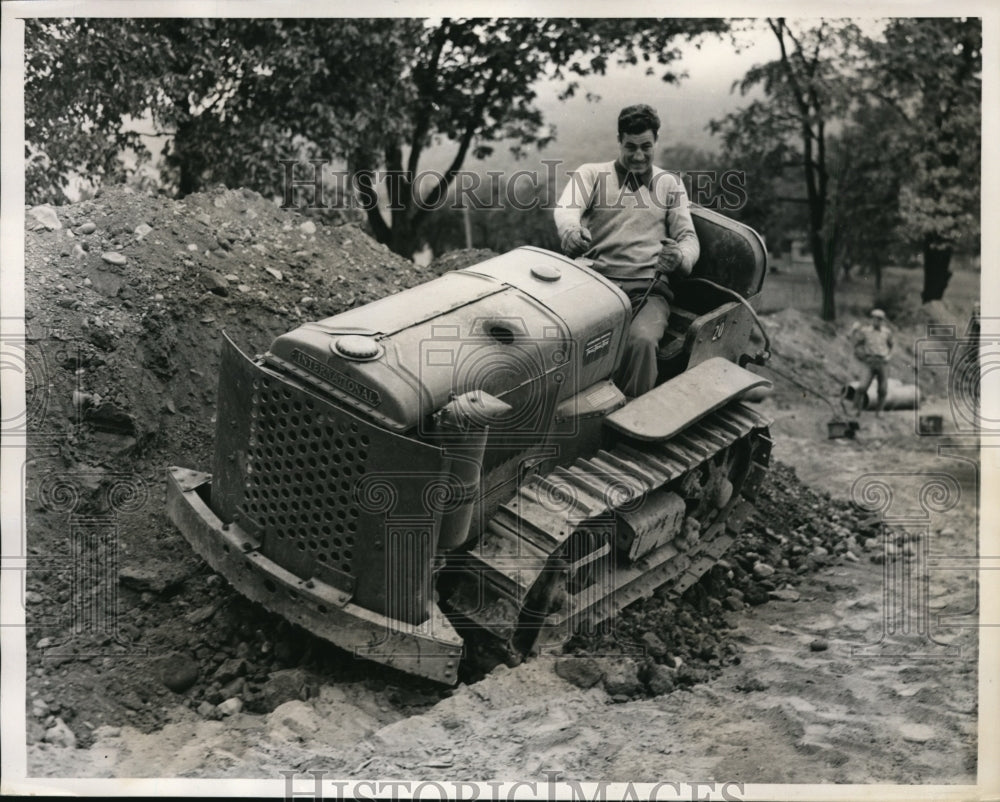 1939 Press Photo Boxer Fred Apostoli on tractor at training camp Elenville NY- Historic Images