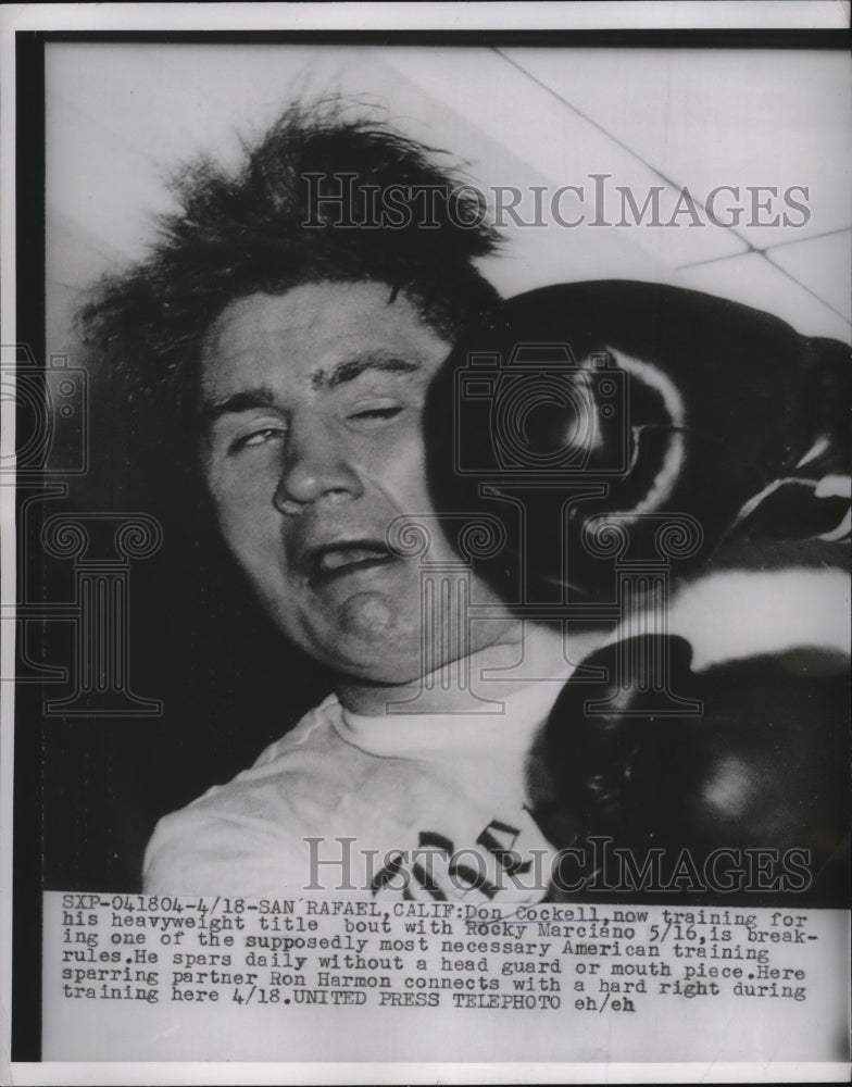 1955 Press Photo Dock Cockell hit in head while training for Rocky Marciano bout- Historic Images