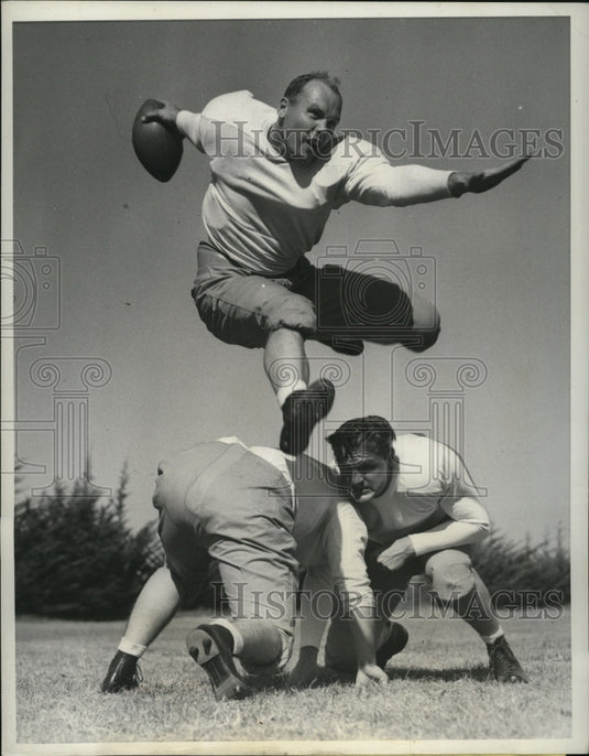 1941 Press Photo Private Jess Willard, Jr. hurdles two fellow Ford Ord players- Historic Images