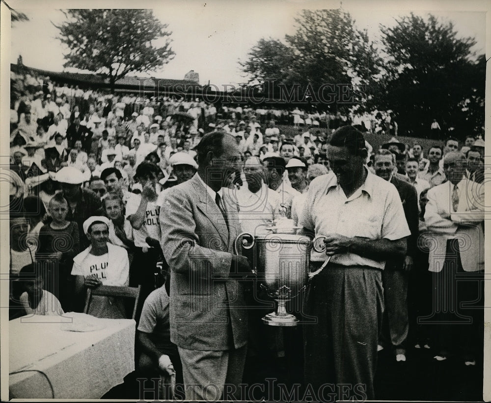 Press Photo winner receiving trophy as crowd looks on - net00325- Historic Images