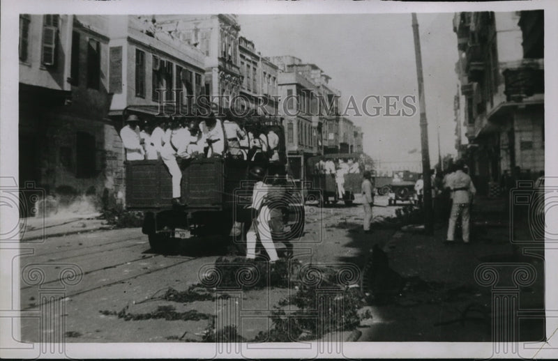 Load image into Gallery viewer, 1930 Press Photo Riots in Cairo Egypt police in trucks to disperse crowds
