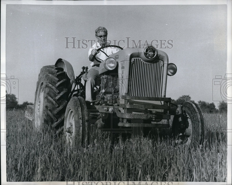 Load image into Gallery viewer, 1959 Press Photo Mrs Lyon on a farm tractor in pastureland
