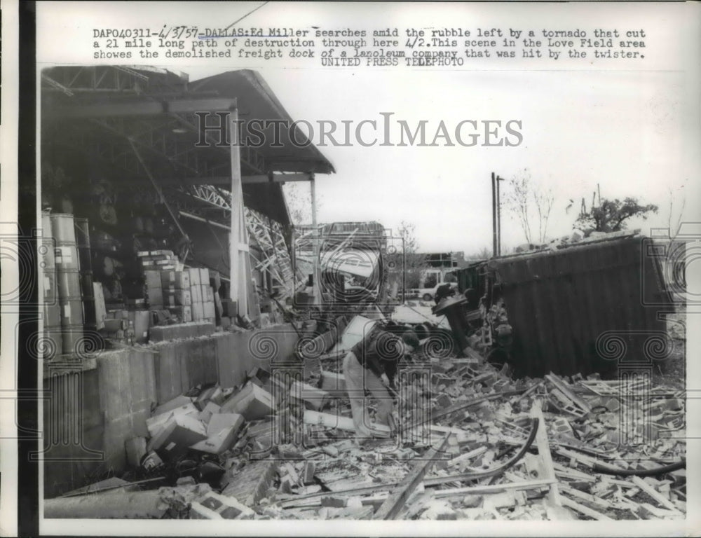 1957 Press Photo Ed Miller Searches Rubble left by Tornado Dlass