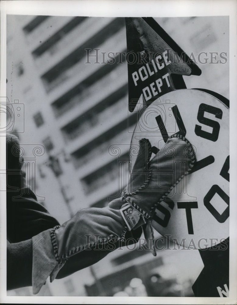 1949 Press Photo Gloves with Money Pouch Displayed at Bus Stop Sign