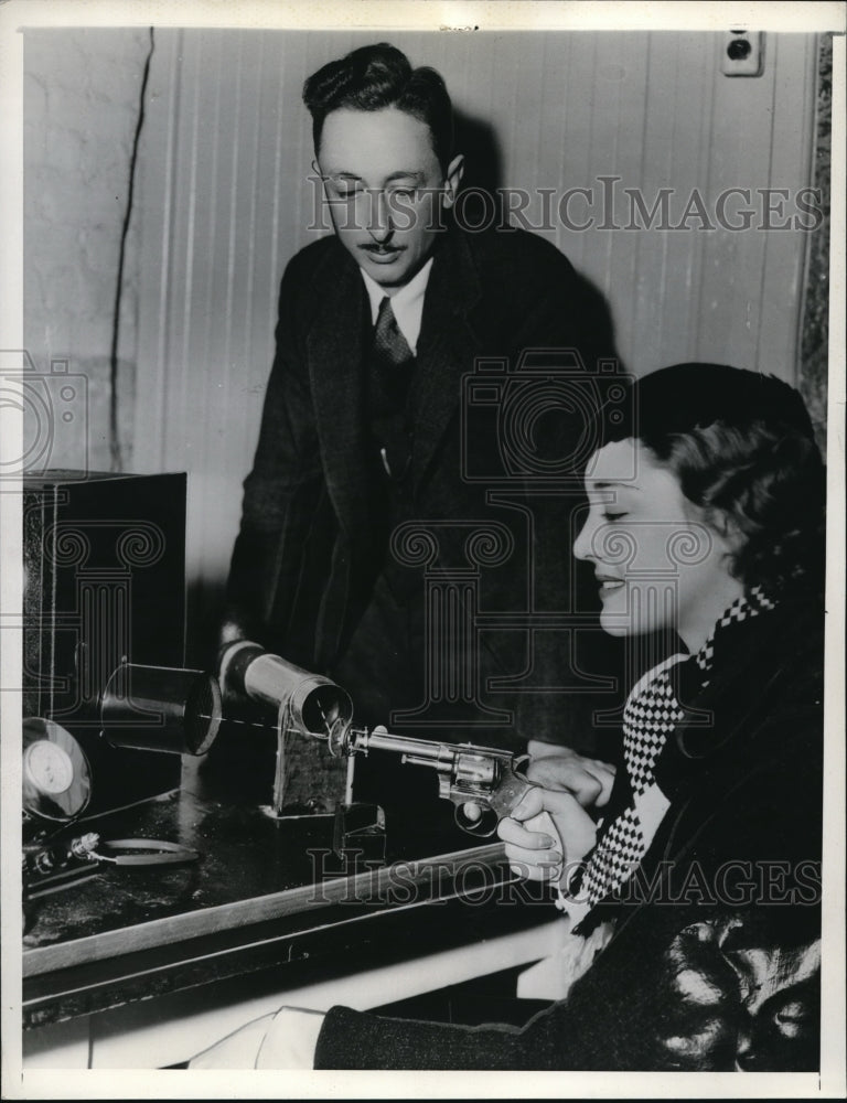 Load image into Gallery viewer, 1935 Press Photo Dr. H.H. Seashire and Kathleen Burke Actress Aims with Pistol.
