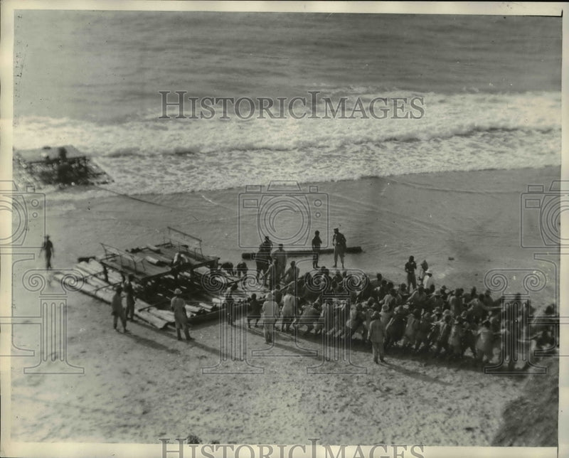 Load image into Gallery viewer, 1929 Press Photo Hauling Raft Ashore at Fernando Noronha Island Brazil
