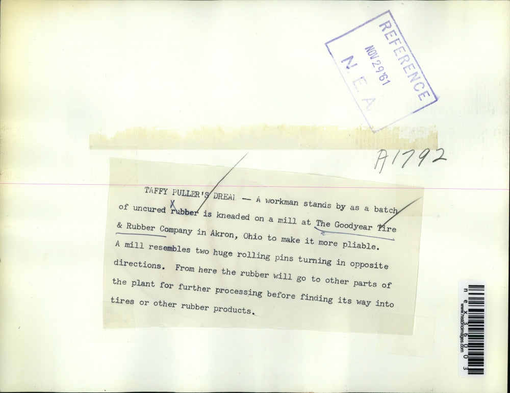 1961 Press Photo Mill Workman Kneading Uncured Rubber Batch, Goodyear Tire Co.