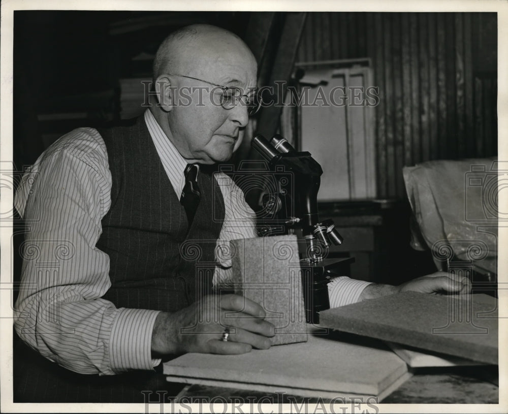 1941 Press Photo A man looking at a microscope