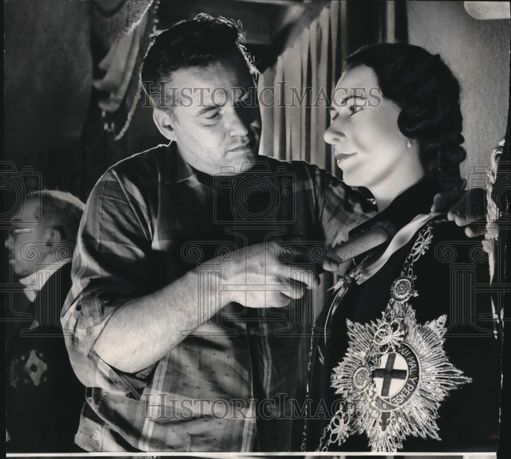 1966 Press Photo Tiberghien brushes royal raiment of Queen Elizabeth II