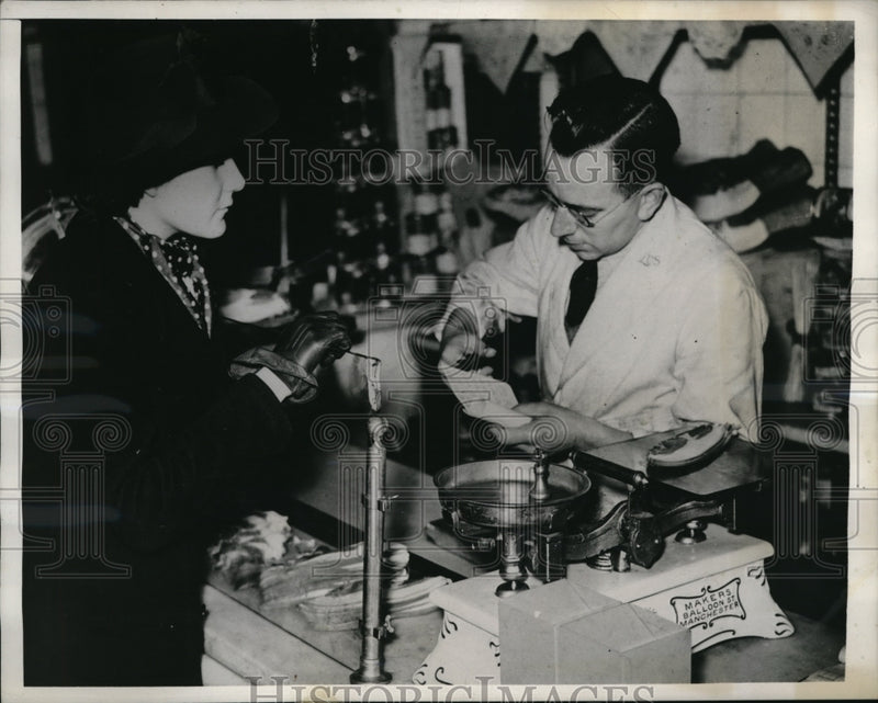 Load image into Gallery viewer, 1940 Press Photo London Shop Clerk Cuts Coupons From Housewife Ration Book
