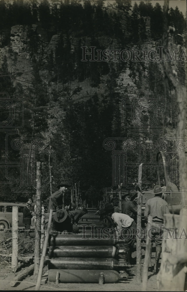 1934 Press Photo Men stacking gas tanks at a military camp