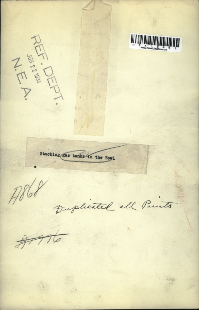 1934 Press Photo Men stacking gas tanks at a military camp