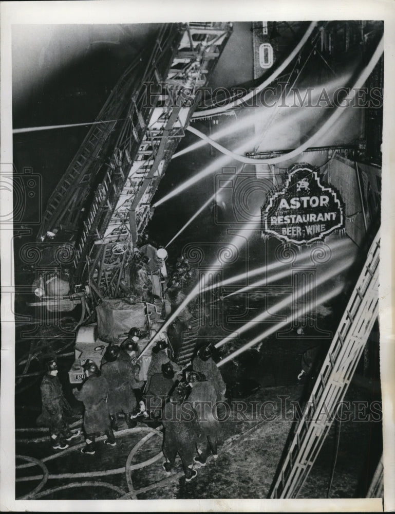 1944 Press Photo Firemen pour water into the Astor Restaurant in Downtown