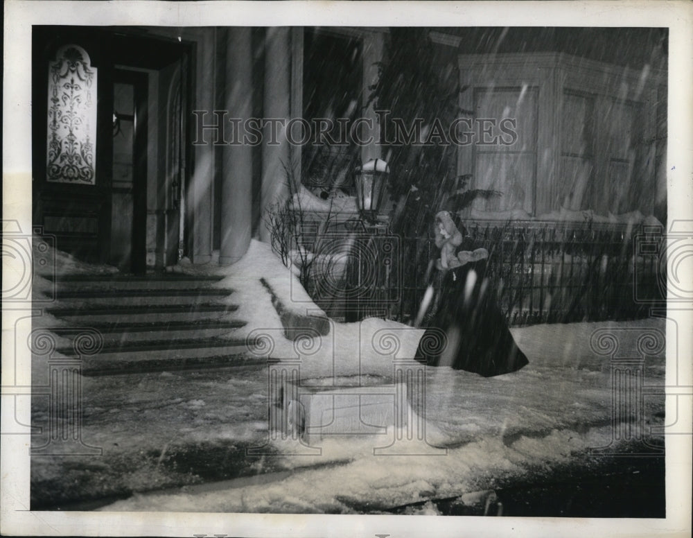 1944 Press Photo Solitary woman walks thru wind blown snow on a street