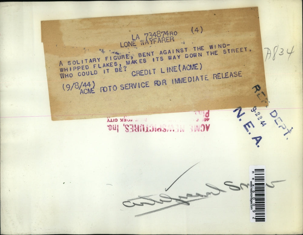 1944 Press Photo Solitary woman walks thru wind blown snow on a street