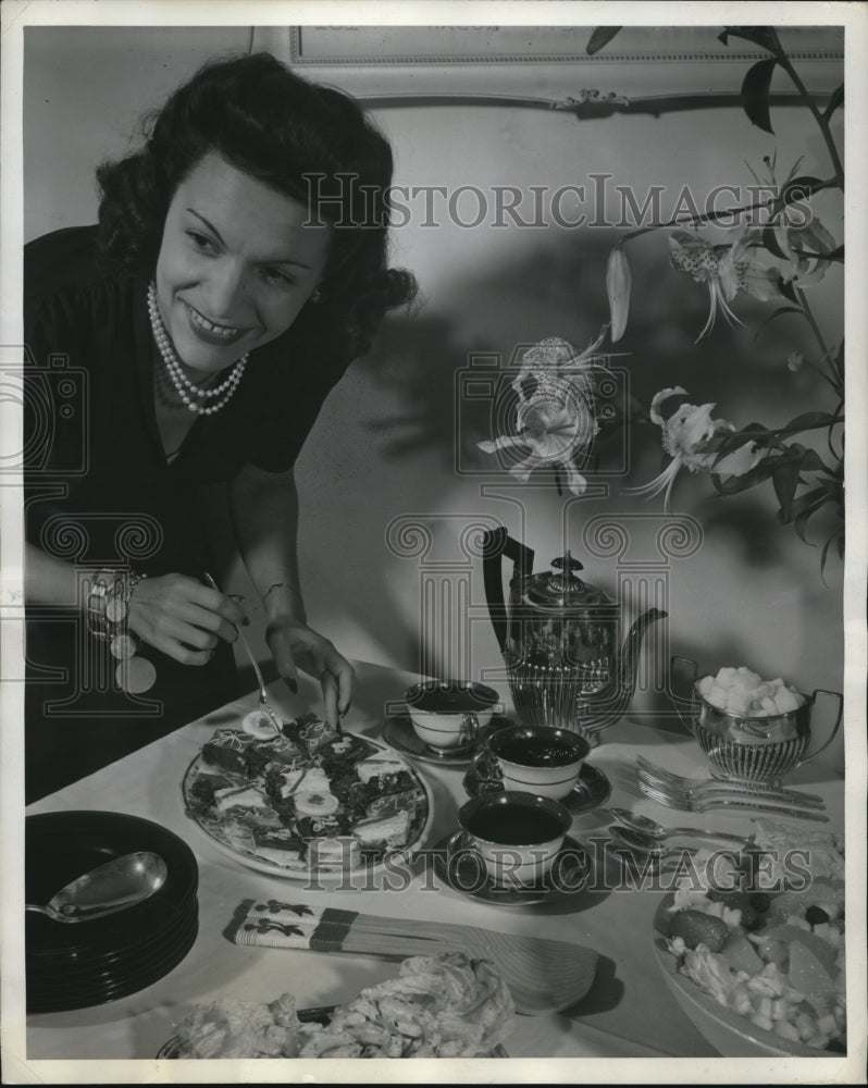 Load image into Gallery viewer, 1941 Press Photo Beatrice Osorio from Columbia serves snak to friend in USA
