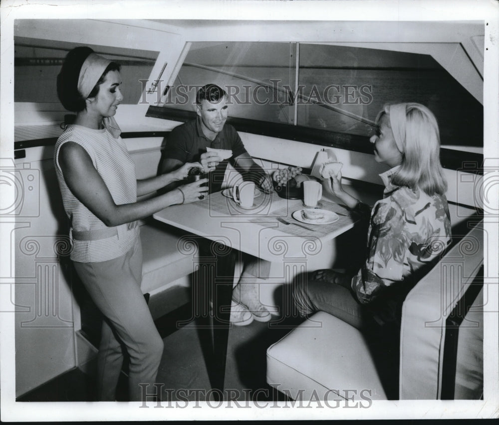 Press Photo A group of people in a boats dinette on 25 fott cabin cruiser