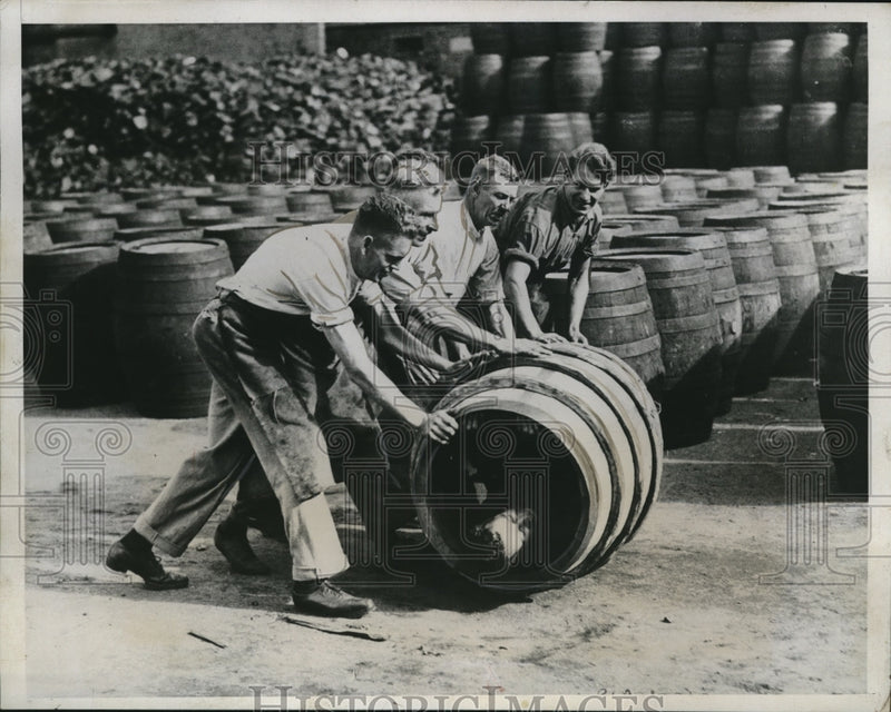Load image into Gallery viewer, 1923 Press Photo British men roll barrells Hernbert Gill

