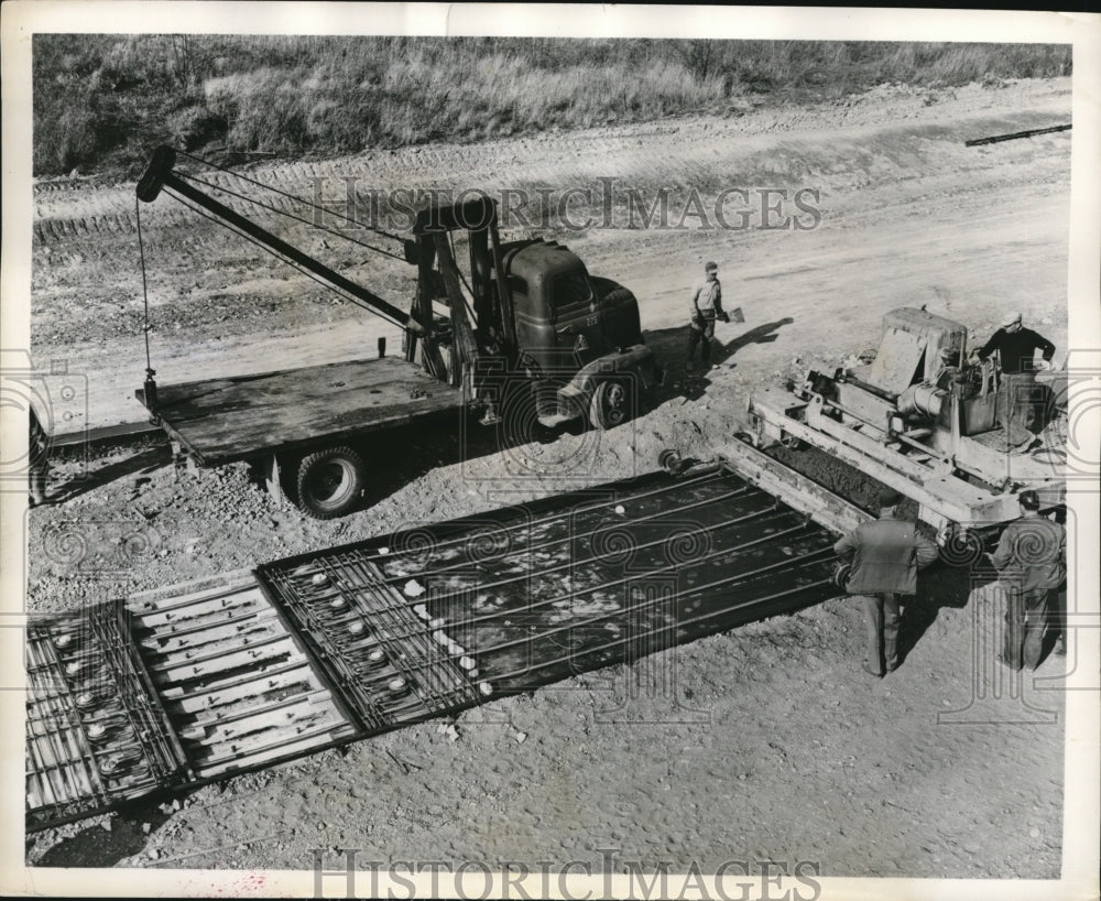 1957 Press Photo Workmen in process of building a road - nex73869