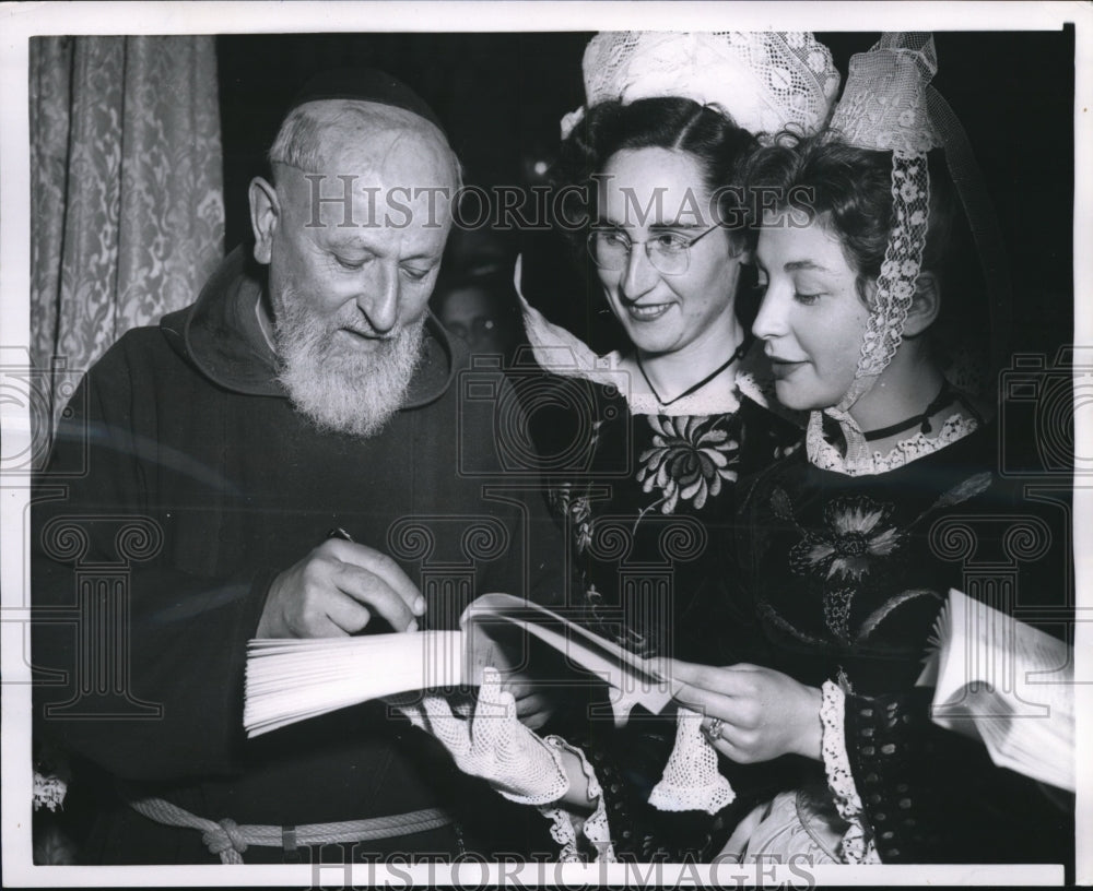 1954 Press Photo Paris Author Father Tvon signs book for Soiion, Mailleson