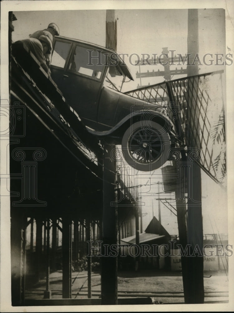 1925 Press Photo Auto Runs Off Bridge Lodged on Telegraph Pole