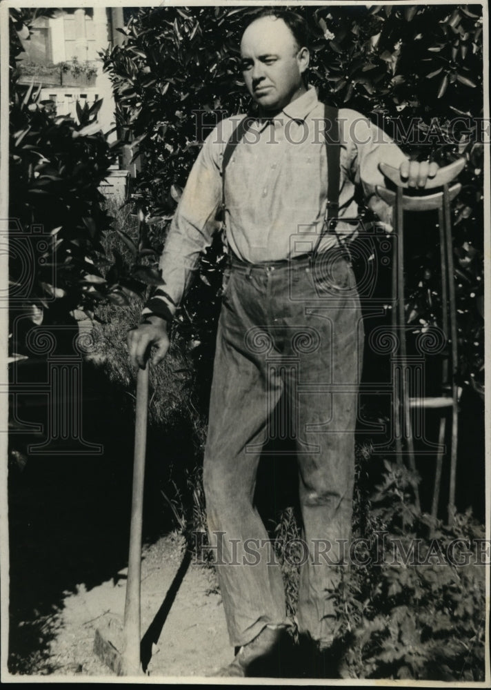 1927 Press Photo Mr Leger on crutches with a pick axe