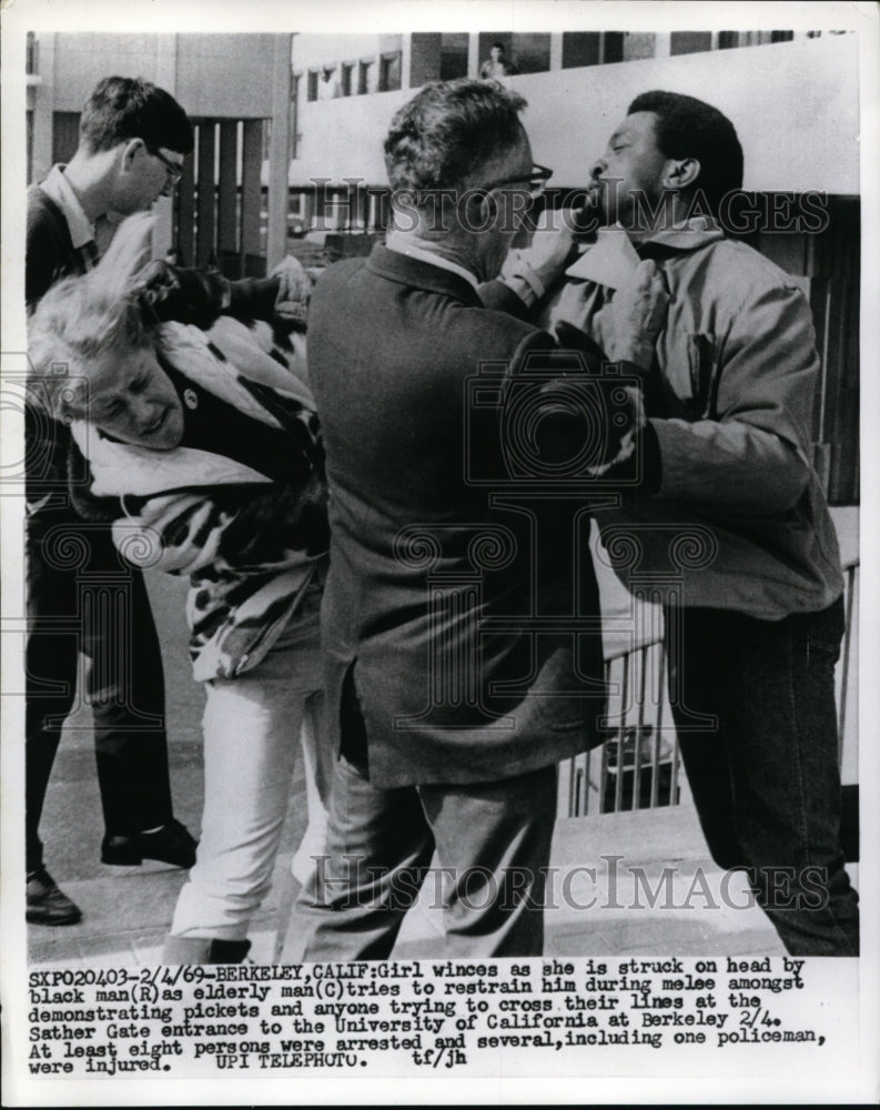 Load image into Gallery viewer, 1969 Press Photo Woman Struck By Black Man at University of California
