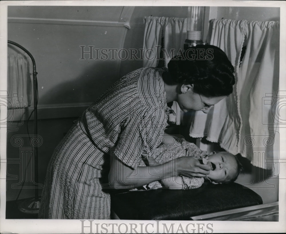 1947 Press Photo A well operated health service checking a baby