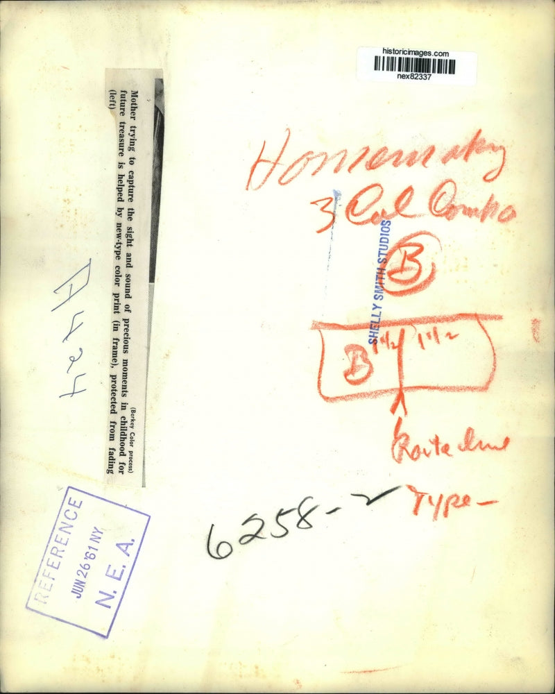 1961 Press Photo A mother tries to save mementos with new type color prints