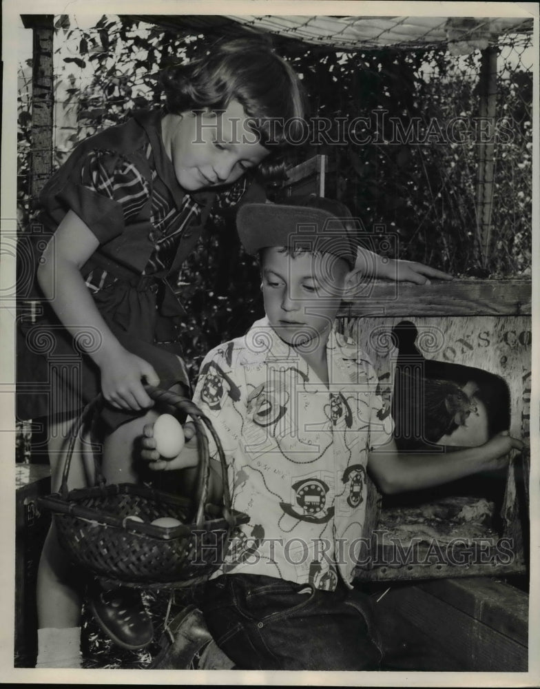 Load image into Gallery viewer, 1953 Press Photo Dick &amp; Dale with eggs for sale in California
